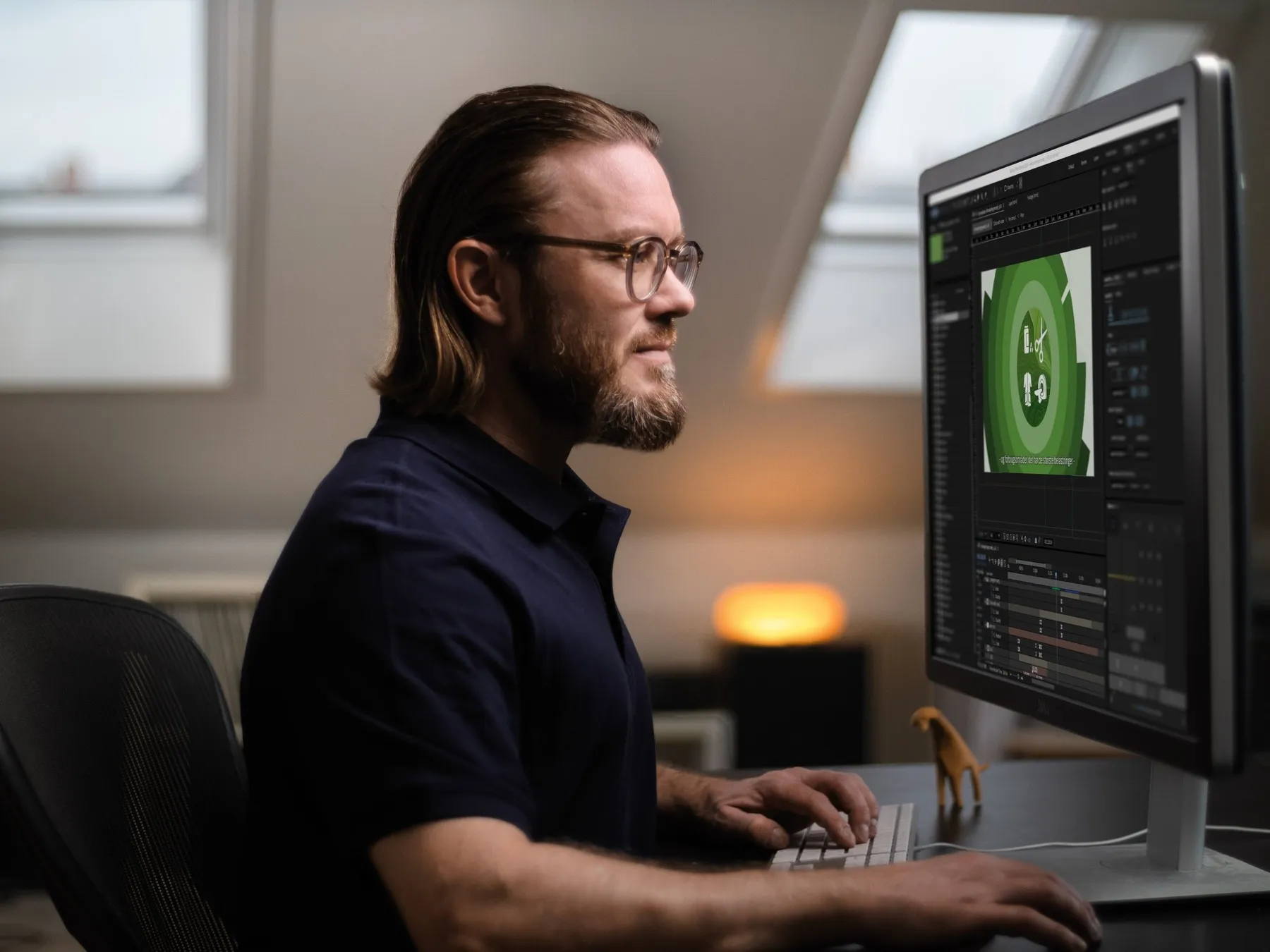Kristoffer Hanghøj at his computer with an animation in After Effects