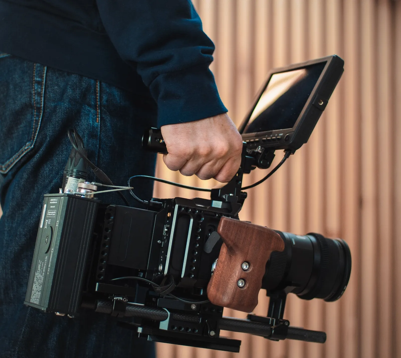 Kristoffer with his cinema camera rigged with a monitor, sound recorder and wooden handle