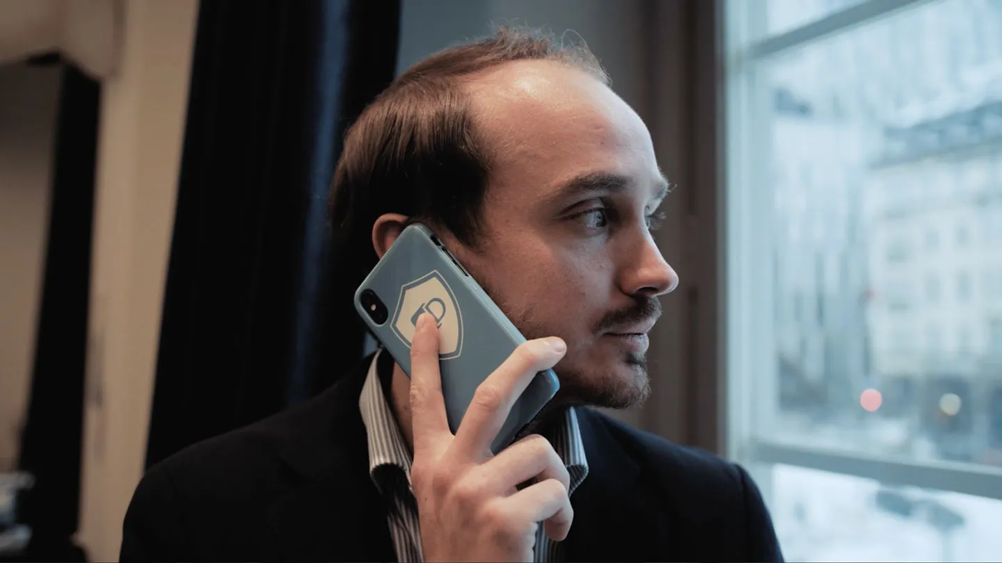 A man on the phone by a window